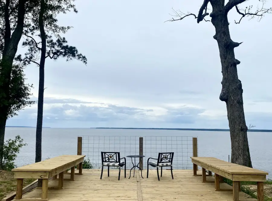 Relax and enjoy the panoramic view from the deck overlooking the lake.